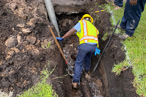 Man Digging to Repair Residential Epoxy Pipeline
